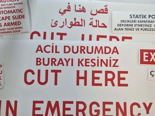 Emergency CUT HERE placard, trilingual